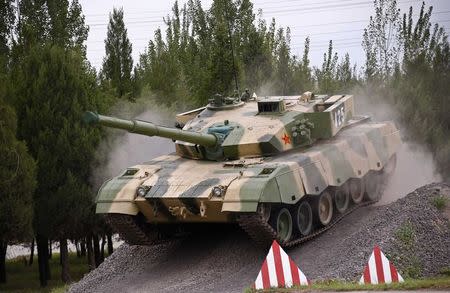 A tank is driven down a slope during an organised media tour at a People's Liberation Army (PLA) engineering academy in Beijing July 22, 2014. REUTERS/Petar Kujundzic