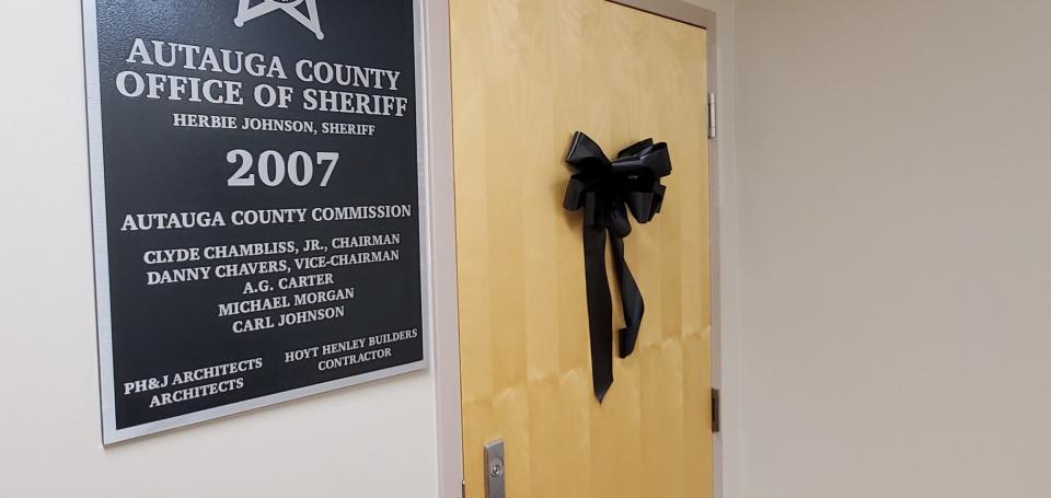 A black bow hangs on the office door of Autauga County Sheriff Joe Sedinger, who died Dec. 26, 2022, after a brief battle with cancer.