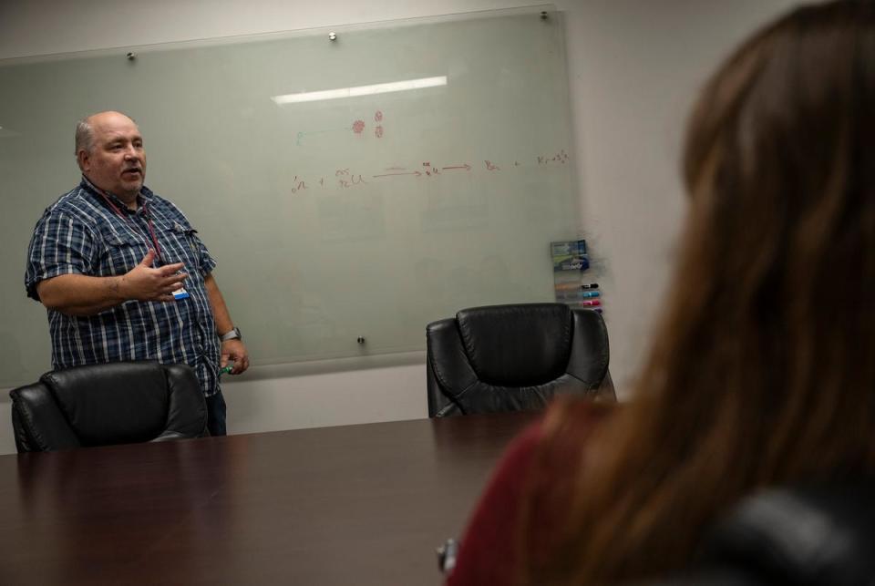 Texas A&M University Nuclear Engineering instructional professor Cable Kurwitz diagrams a simple explanation for the process of nuclear fission Monday, March 11, 2024 in College Station.