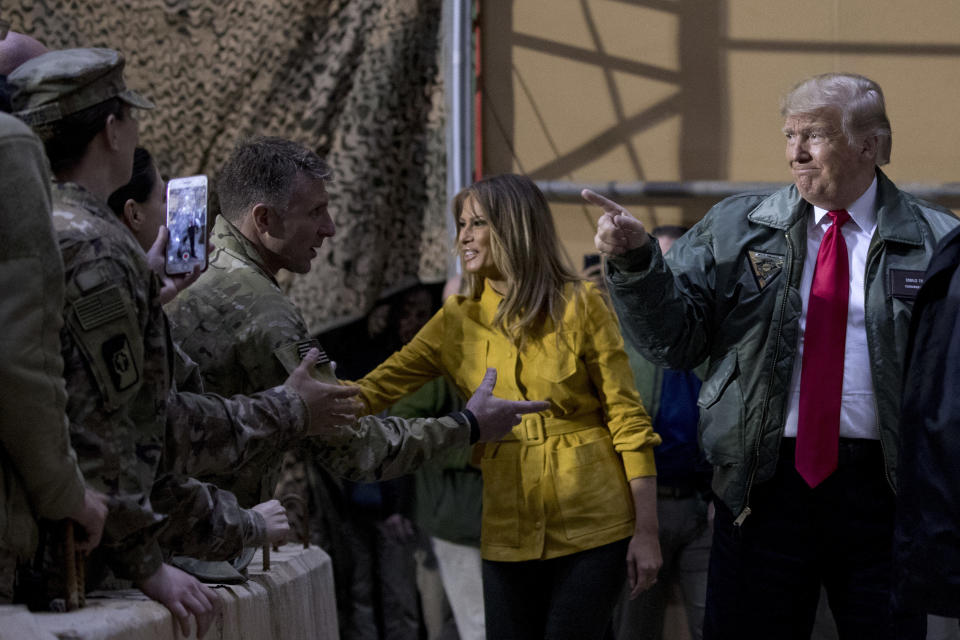 President Donald Trump and first lady Melania Trump greet members of the military at a hangar rally at Al Asad Air Base, Iraq, Wednesday, Dec. 26, 2018. (AP Photo/Andrew Harnik)