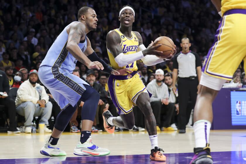 8LOS ANGELES, CALIF. - MAR. 7, 2023. Los Angeles Lakers guard Dennis Schroder, right, drives to the basket past Memphis Grizzlies forward Xavier Tillman in an NBA game at Crypto.com Arena in Los Angeles on Tuesday, Mar. 7, 2023. (Luis Sinco / Los Angeles Times)