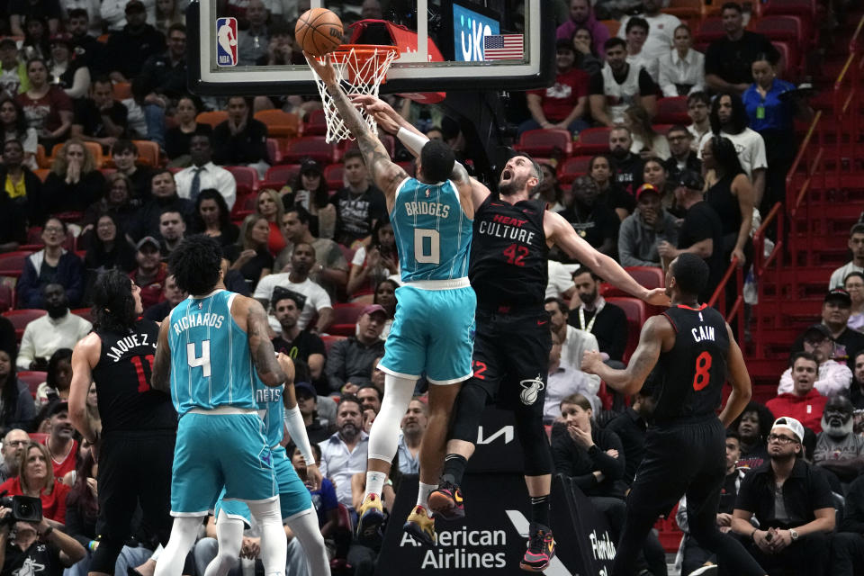 Charlotte Hornets forward Miles Bridges (0) goes to the basket as Miami Heat forward Duncan Robinson (55) defends during the first half of an NBA basketball game, Wednesday, Dec. 13, 2023, in Miami. (AP Photo/Lynne Sladky)