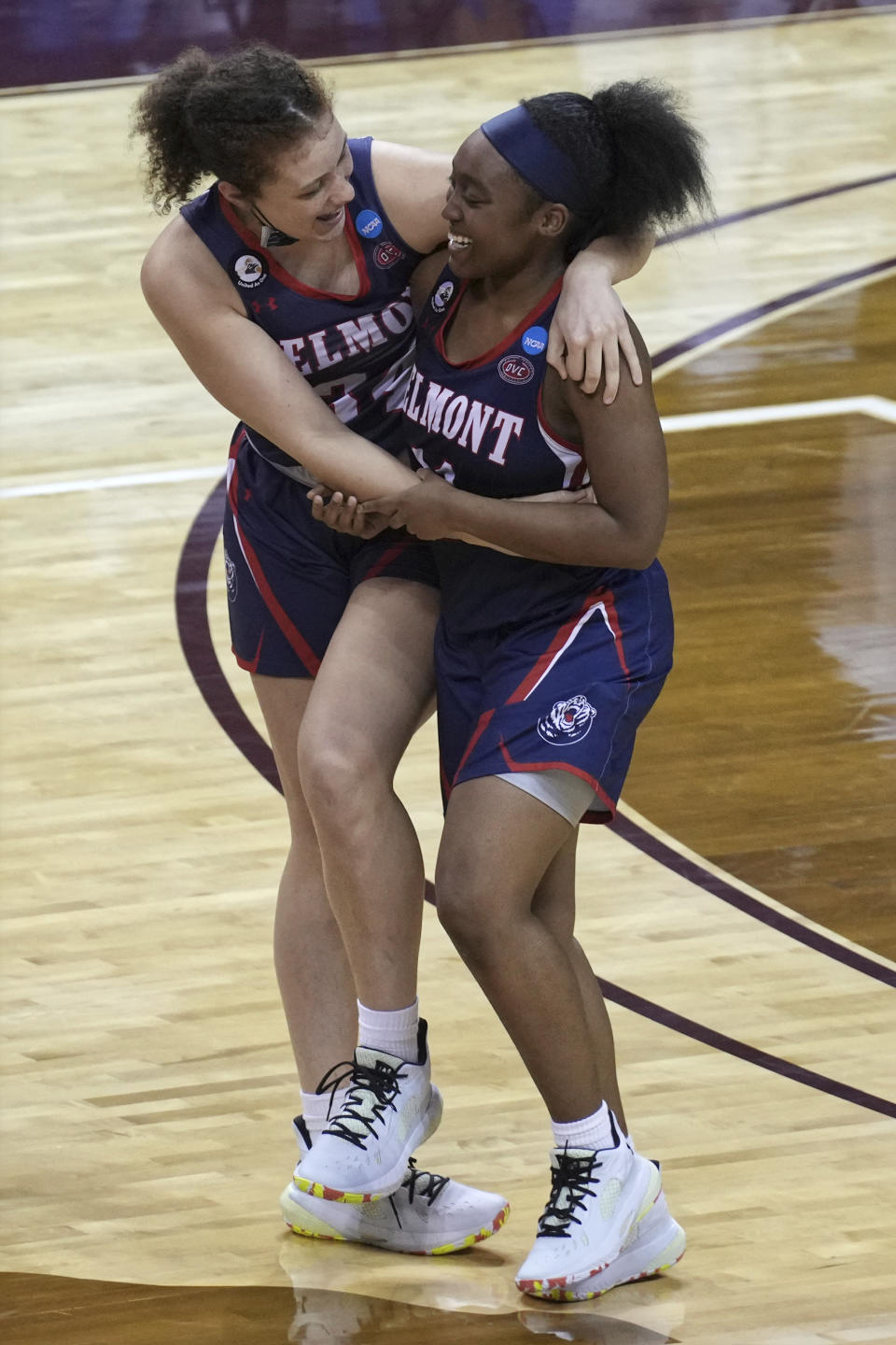 Destinee Wells, right, celebrates with Cam Browning, left, after Belmont's win over Gonzaga in a college basketball game in the first round of the women's NCAA tournament at the University Events Center in San Marcos, Texas, Monday, March 22, 2021. (AP Photo/Chuck Burton)