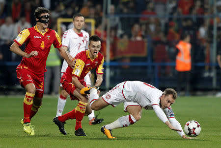 Soccer Football - 2018 World Cup Qualifications - Europe - Montenegro vs Denmark - Podgorica City Stadium, Podgorica, Montenegro - October 5, 2017 Denmark's Christian Eriksen in action with Montenegro's Mirko Ivanic (C) and Nikola Vukcevic (L) REUTERS/Stevo Vasiljevic