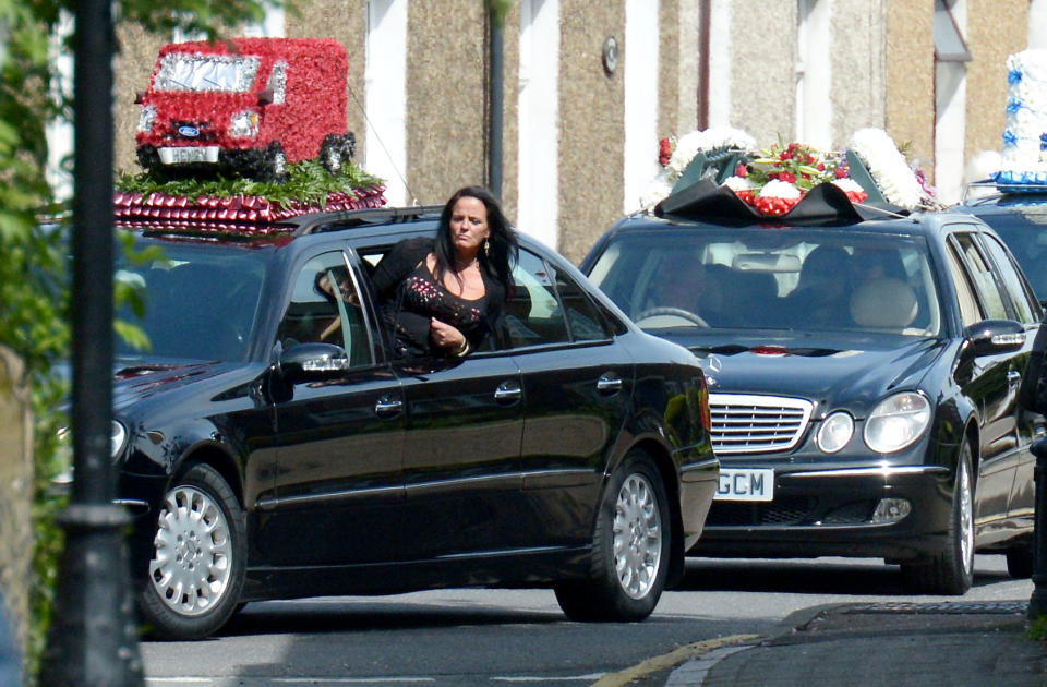 A mourner looks ahead from a window of the funeral procession for Henry Vincent in south London. (SWNS)