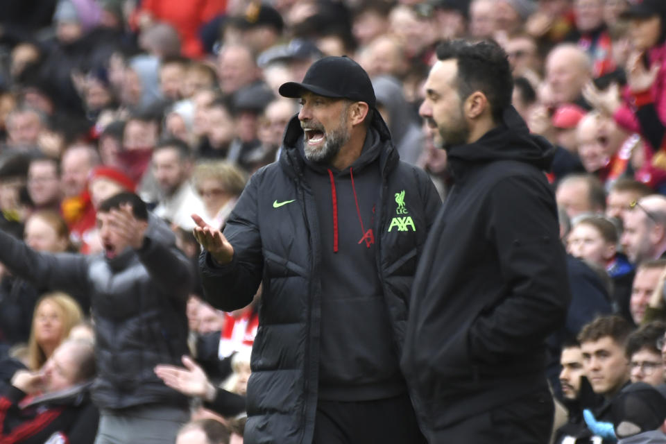 Liverpool's manager Jurgen Klopp, left, reacts during the English Premier League soccer match between Liverpool and Brighton and Hove at Anfield Stadium in Liverpool, England, Sunday, March 31, 2024. (AP Photo/Rui Vieira)