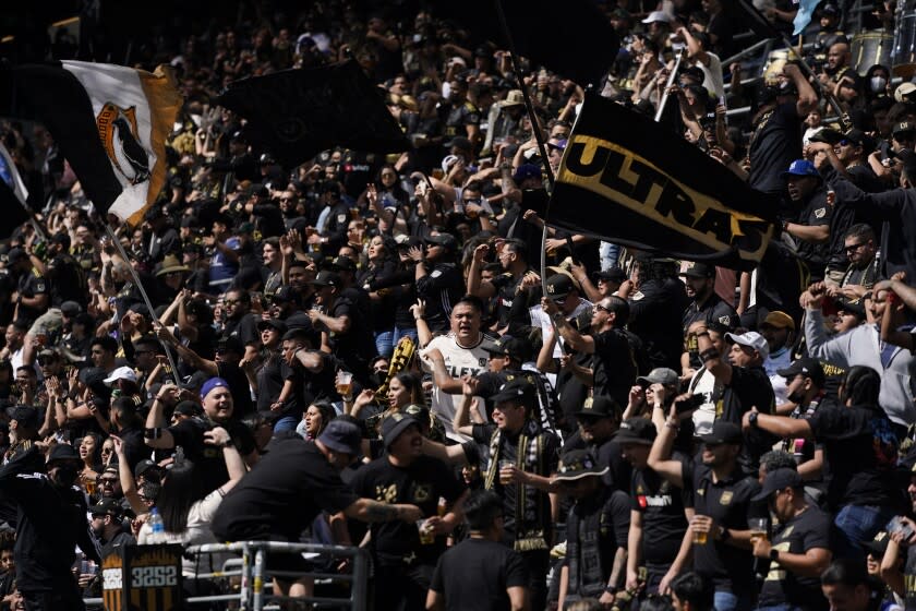 Los Angeles FC fans cheer before the team's MLS soccer match against the Colorado Rapids Saturday, Feb. 26, 2022, in Los Angeles. (AP Photo/Jae C. Hong)