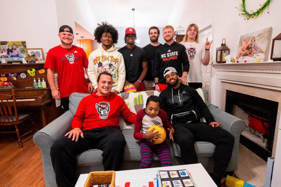 Grayson Ketchie, 12, poses with N.C. State football players who paid a surprise visit to Ketchie’s home in Garner Wednesday, Oct. 18, 2023. Next to Grayson is Dylan McMahon, left, and Trent Pennix. In the top row, from left, stand Brayden Narveson, KC Concepcion, MJ Morris, Payton Wilson, Brennan Armstrong and Dawson Jaramillo.