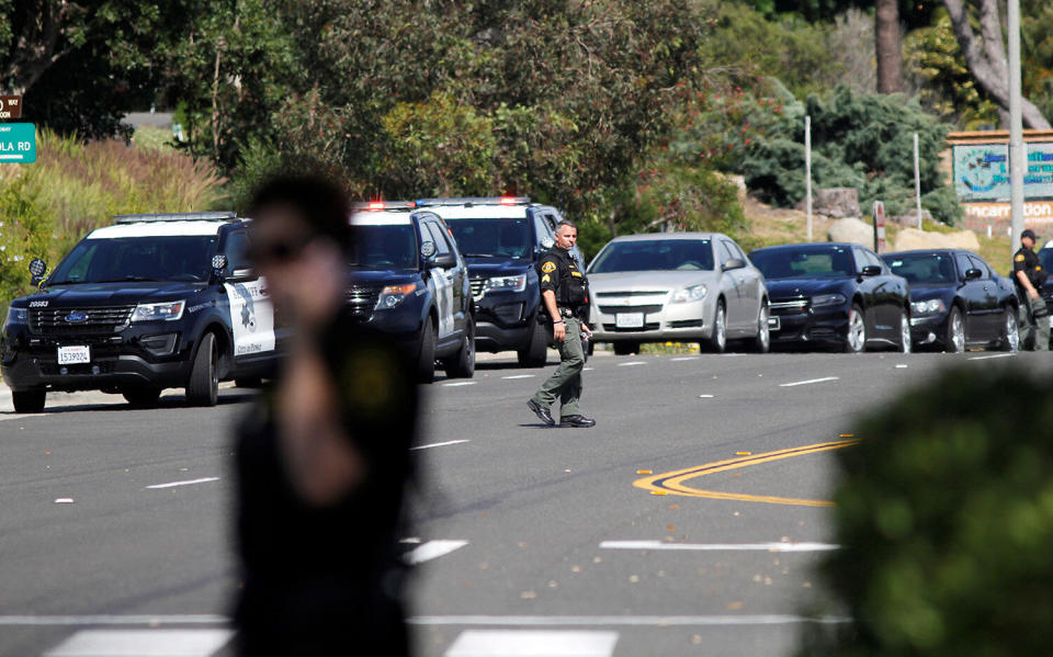 A San Diego Sheriffís Deputy walks near the scene of a shooting incident at the Congregation Chabad synagogue in Poway, north of San Diego, April 27, 2019. (Photo: John Gastaldo/Reuters)