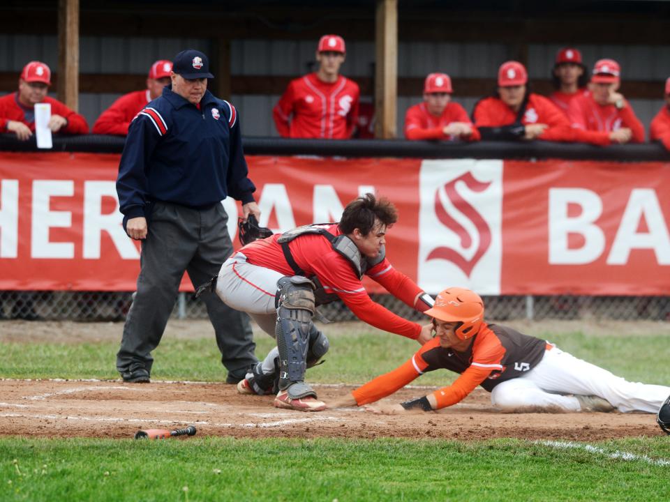 Then-sophomore catcher Caden Sheridan of Thornville Sheridan tags out Byesville Meadowbrook's Damen Launder on a play at the plate on May 5, 2022. Sheridan went on to earn all-state honors that season and last, and is one of this season's top players to watch.