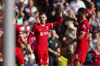 Liverpool's Andrew Robertson, center, is congratulated after scoring his side's 2nd goal during the English Premier League soccer match between Liverpool and Tottenham Hotspur at Anfield Stadium in Liverpool, England, Sunday, May 5, 2024. (AP Photo/Jon Super)