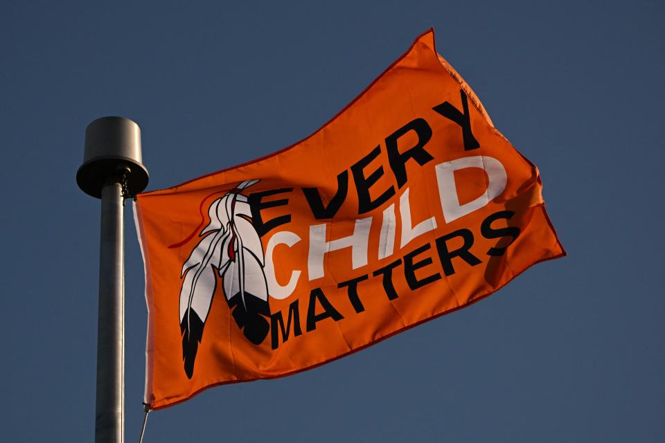 An orange Every Child Matters flag flies outside the Ermineskin Junior Senior High School in Maskwacis, Alberta, on July 23, 2022, ahead of Pope Francis' visit to Canada.