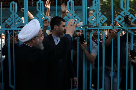 Iran's President Hassan Rouhani waves to supporters at a polling station during the presidential election in Tehran, Iran, May 19, 2017. President.ir/Handout via REUTERS