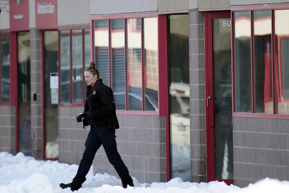 A law enforcement officer exits the Starts Right Here building, Monday, Jan. 23, 2023, in Des Moines, Iowa. Police say two students were killed and a teacher was injured in a shooting at the Des Moines school on the edge of the city's downtown. (AP Photo/Charlie Neibergall)