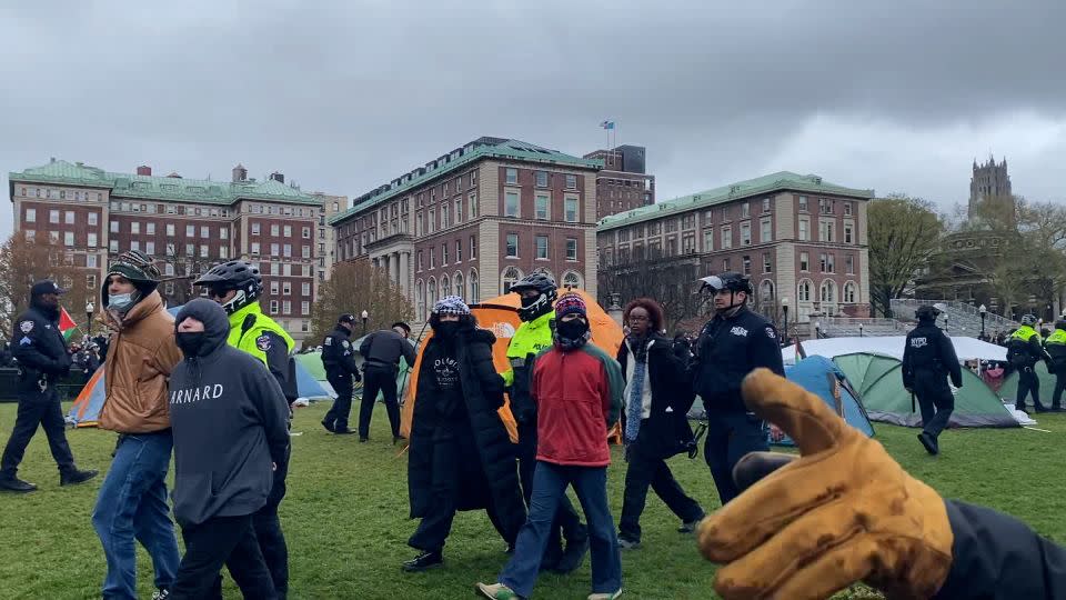 Rep. Ilhan Omar's daughter Isra Hirsi, right, being arrested. - CNN