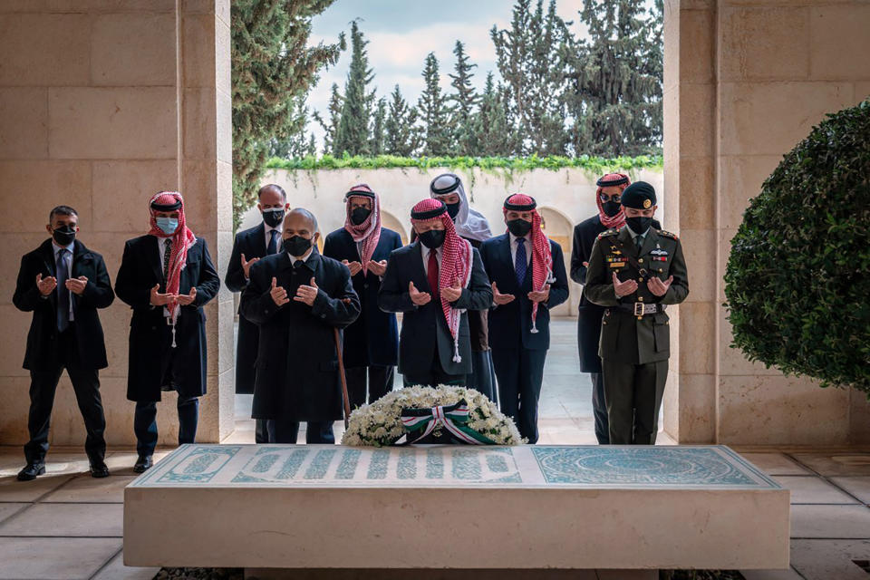 FILE - This April 11, 2021 file photo from the Royal Court twitter account, shows Jordan's King Abdullah II, center, Prince Prince Hamzah, second left, and others during a visit to the tomb of the late King Hussein, in Amman Jordan. Jordan's version of a trial of the century gets under way as early as Monday, June 21, 2021. A relative of King Abdullah II and a former chief of the royal court will be ushered into the defendants’ cage at the state security court to face sedition charges. They are accused of conspiring with Prince Hamzah, a half-brother of the king, to foment unrest against the monarch. (Royal Court Twitter Account via AP, File)