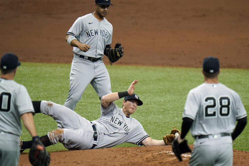 New York Yankees third baseman DJ LeMahieu makes a diving catch on an infield popout by Tampa Bay Rays' Mike Zunino during the second inning of a baseball game Friday, April 9, 2021, in St. Petersburg, Fla. (AP Photo/Chris O'Meara)
