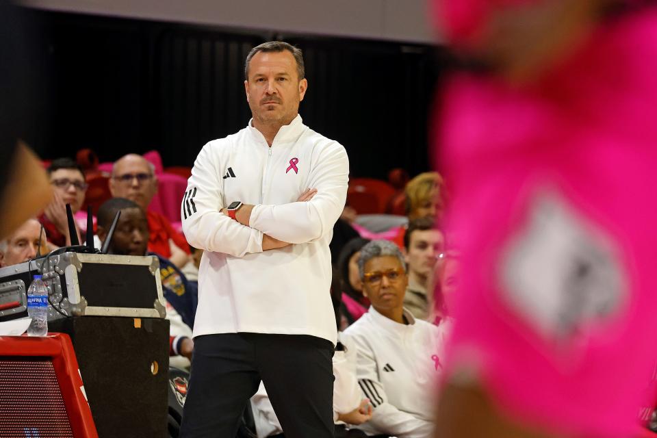 Louisville head coach Jeff Walz, center, watches from the sideline during the second half of an NCAA college basketball game against North Carolina State, Monday, Feb. 5, 2024, in Raleigh, N.C. (AP Photo/Karl B. DeBlaker)