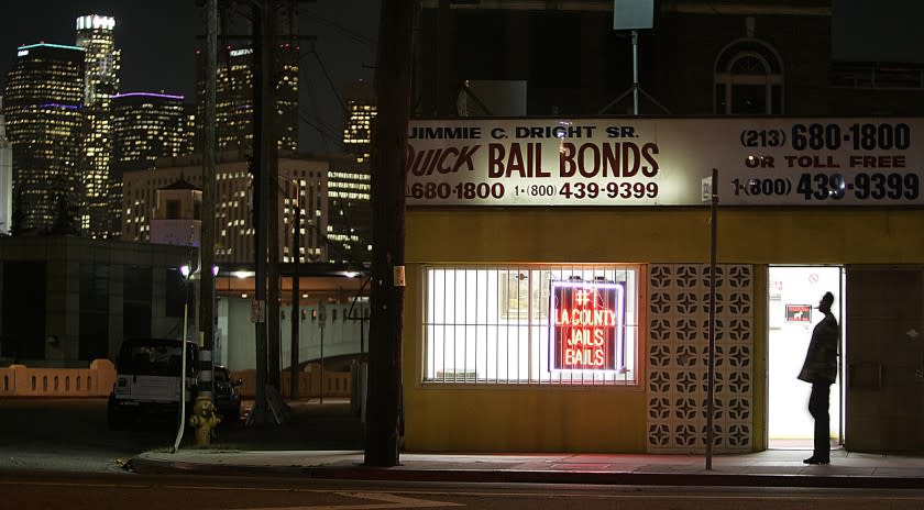 Gauthier, Robert –– – 093232.ME.0207.bail1.RCG –– The lights of downtown Los Angeles shine behind the Quick Bail Bonds building on Vignes Street across from Men's Central Jail, Monday, February 7, 2005.