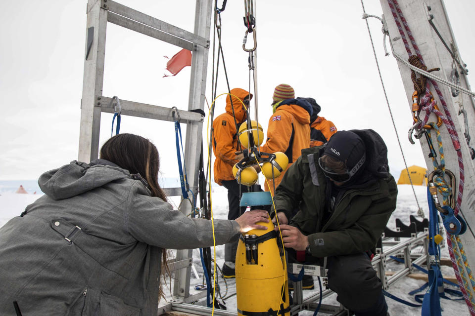 A robot nicknamed Icefin is deployed at Thwaites glacier in Antarctica in January 2020. The pencil-shaped robot is giving scientists their first look at the forces eating away at the Thwaites glacier. Two studies published Wednesday, Feb. 15, 2023, show the rate of melting isn't as fast as feared, but fracturing is taking the heaviest toll on the glacier. (Dichek/Icefin/ITGC via AP)