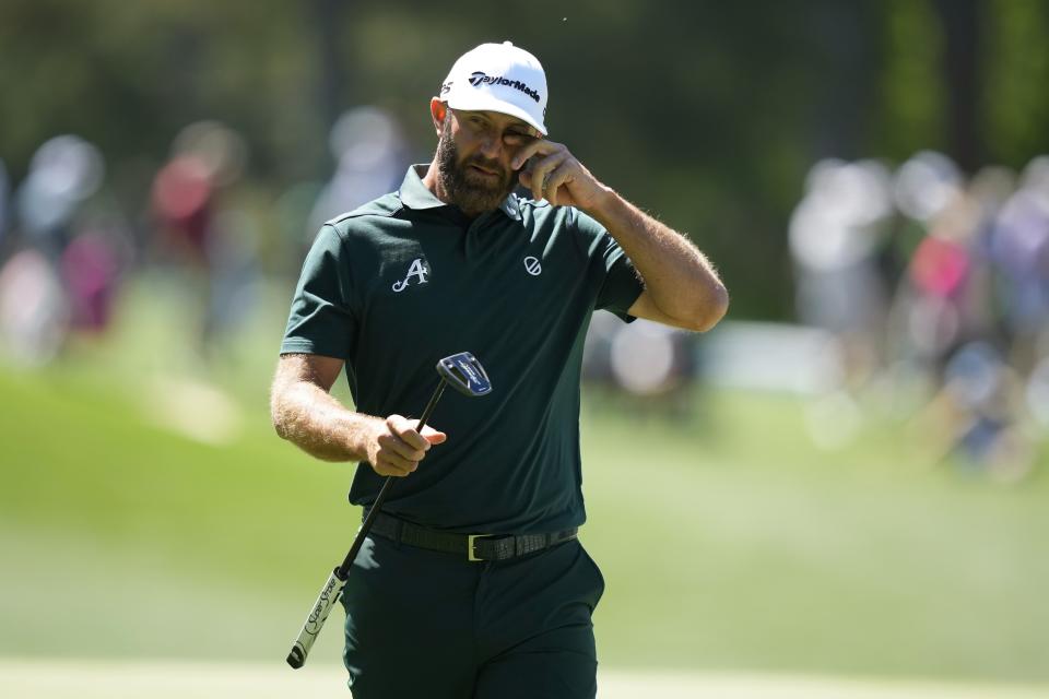 Dustin Johnson wipes his eye on the third hole during second round at the Masters golf tournament at Augusta National Golf Club Friday, April 12, 2024, in Augusta, Ga. (AP Photo/Matt Slocum)
