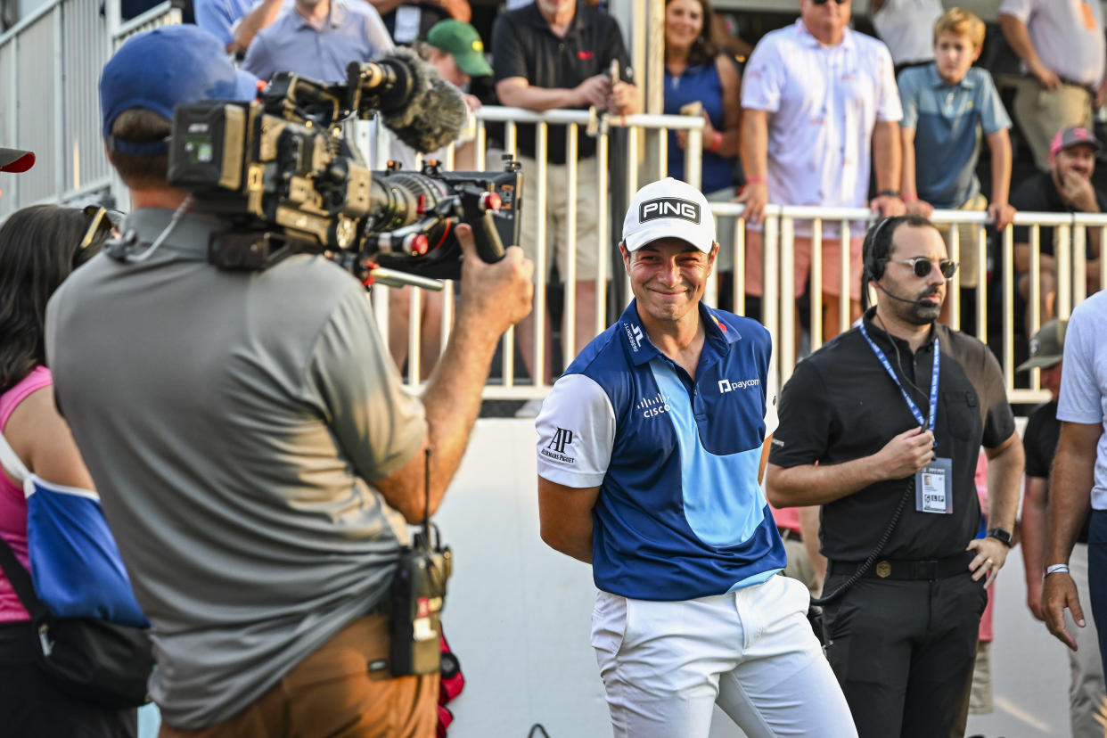  Viktor Hovland of Norway smiles for a camera filming for the Netflix Full Swing series.