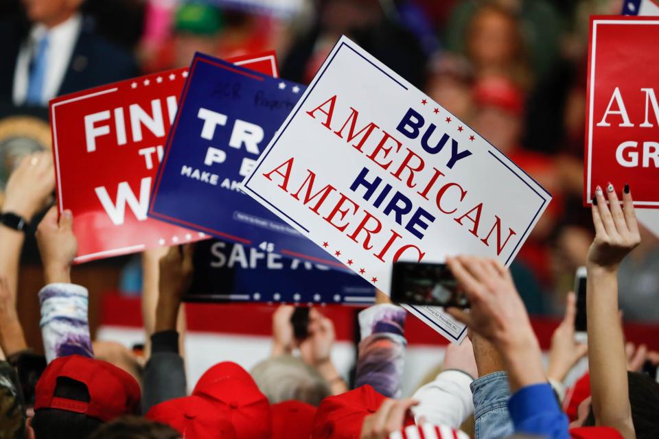 Trump supporters wave signs during a rally for Republican candidate Mike Braun at Southport Fieldhouse on Friday, Nov. 2, 2018. 