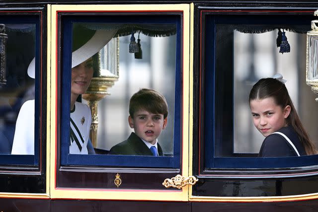 <p>Victoria Jones/Shutterstock </p> Kate Middleton, Prince Louis and Princess Charlotte ride in a carriage at Trooping the Colour on June 15, 2024