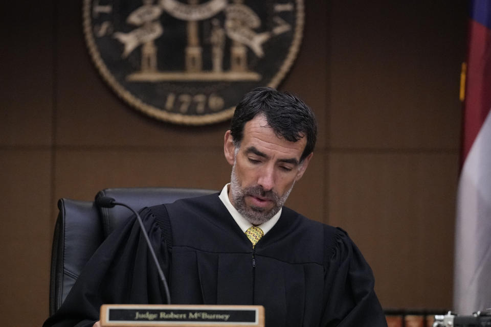 FILE - Fulton County Superior Court Judge Robert McBurney looks through paperwork, Monday, Aug. 14, 2023, in Atlanta. A judge on Friday, Sept. 8, is expected to release the full report compiled by a special grand jury that helped an investigation by the Georgia prosecutor who ultimately indicted former President Donald Trump and 18 others. (AP Photo/Brynn Anderson, File)