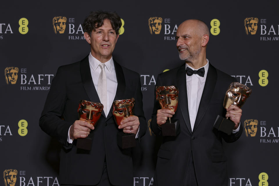 El director Jonathan Glazer, izquierda, y el productor James Wilson, ganadores del premio a mejor película británica y película en habla no inglesa por 'The Zone of Interest' posan en la 77a entrega de los Premios de la Academia Británica de Cine (BAFTA) en Londres el domingo 18 de febrero de 2024. (Foto Vianney Le Caer/Invision/AP)