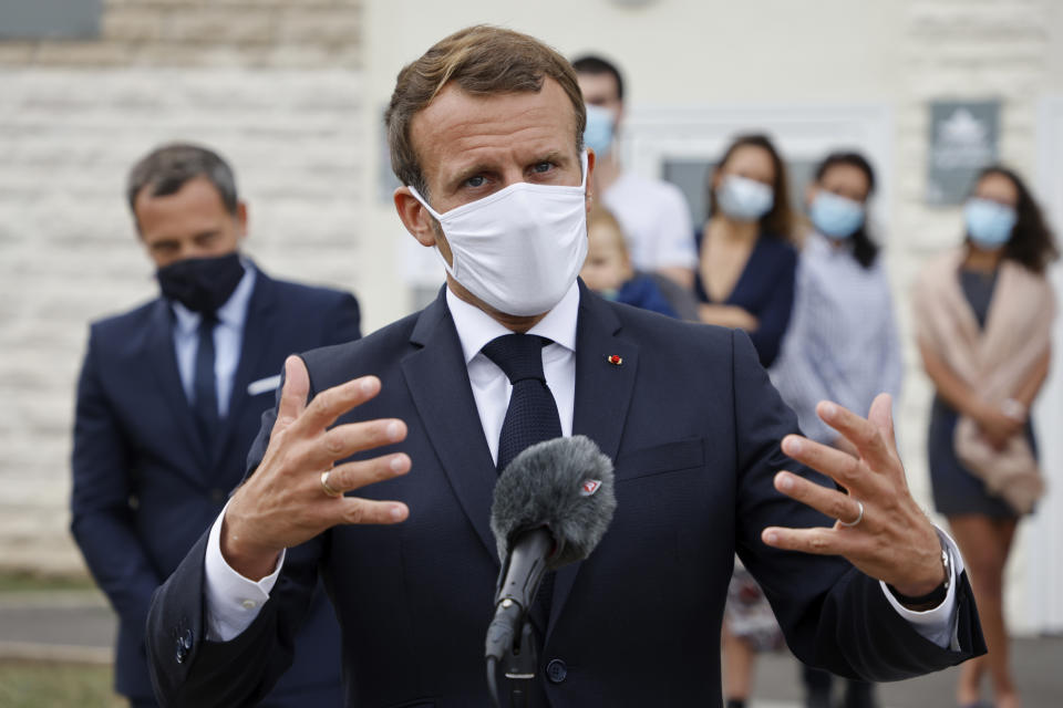 French President Emmanuel Macron speaks after visiting a Mother and Child Protection Centre (PMI) in Longjumeau, a southern suburb of Paris, Wednesday, Sept. 23, 2020. French President wants to expand paternity leave to one month — and require fathers to take time off with their newborns. President Emmanuel Macron earlier announced the plan on Instagram before visiting the child-care facility. (Ludovic Marin/POOL via AP)