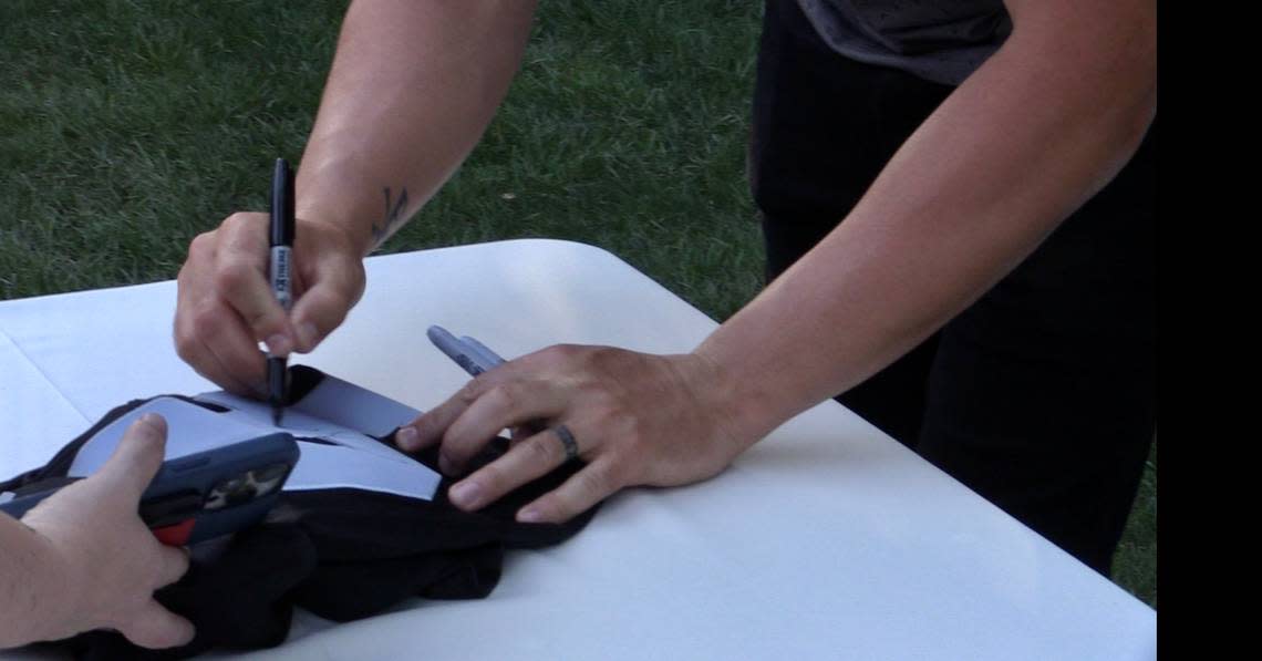 New Orleans Saints quarterback Derek Carr signs a Raiders jersey at the annual DC4Kids event on Saturday, June 24, 2023. Carr was released by the Raiders earlier this year after spending nine seasons with the franchise. ANTHONY GALAVIZ/agalaviz@fresnobee.com