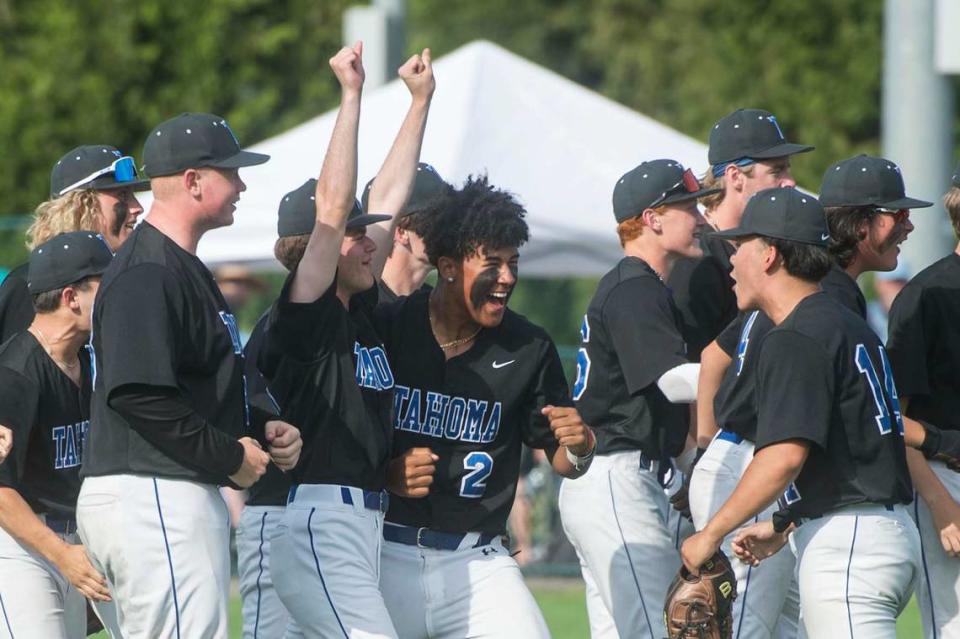 Tahoma starter Adam Jay (14) celebrates with teammates following a win over Olympia in the Class 4A baseball state quarterfinals on Saturday, May 20, 2023 at the Regional Athletic Complex in Lacey, Wash.