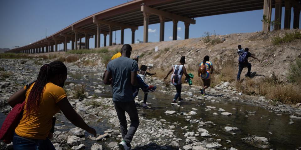Migrants cross Rio Bravo from Mexico to US