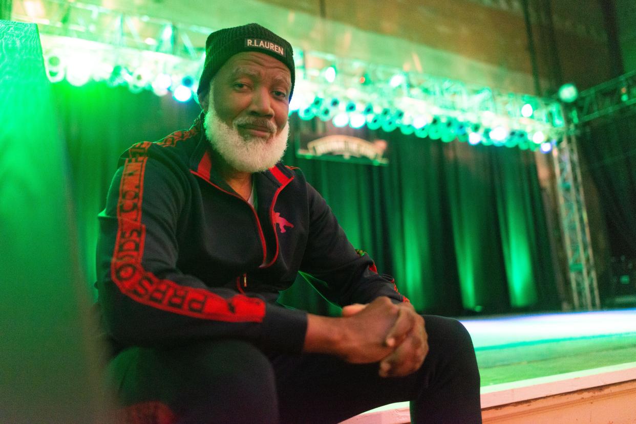 Singer Eddie Wakes sits on the stage Tuesday of the Jayhawk Theatre, where he will be performing as part of his "Boundless" tour this Saturday. The Topeka native has worked on soundtracks to movies and been featured in documentary films.