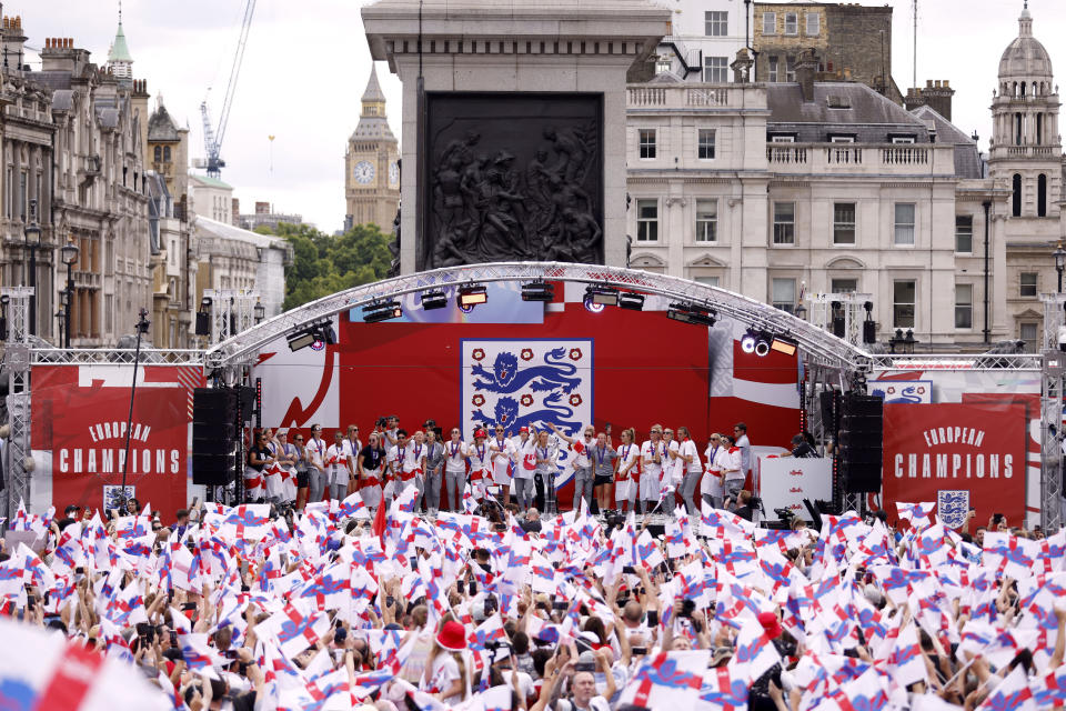 England players celebrate on stage at an event in Trafalgar Square in London, Monday, Aug. 1, 2022. England beat Germany 2-1 and won the final of the Women's Euro 2022 on Sunday. (Steven Paston/PA via AP)