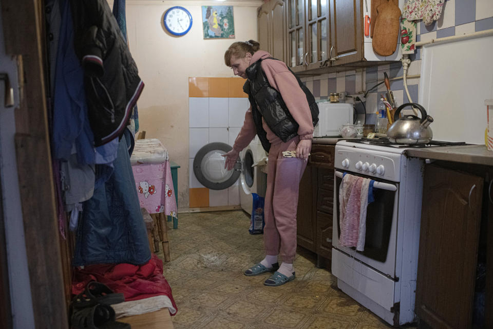 Iryna Stetcenko shows her flooded apartment in the village of Demydiv, about 40 kilometers (24 miles) north of Kyiv, Ukraine, Tuesday, Nov. 2, 2022. Environmental damage caused by Ukraine’s war is mounting in the 8-month-old conflict, and experts warn of long-term health consequences for the population. The World Wildlife Fund in Ukraine says more than 6 million people have limited or no access to clean water. “We don’t have another option. We don’t have money to buy bottles,” Iryna Stetcenko told The Associated Press. (AP Photo/Andrew Kravchenko)