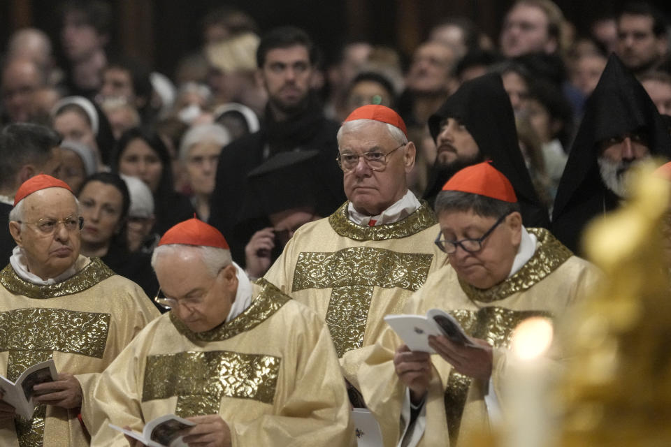 Cardinal Gerhard Ludwig Mueller, 3rd from left, attends the Christmas eve Mass celebrated by Pope Francis, at St. Peter's Basilica at the Vatican, Sunday Dec. 24, 2023. (AP Photo/Gregorio Borgia)