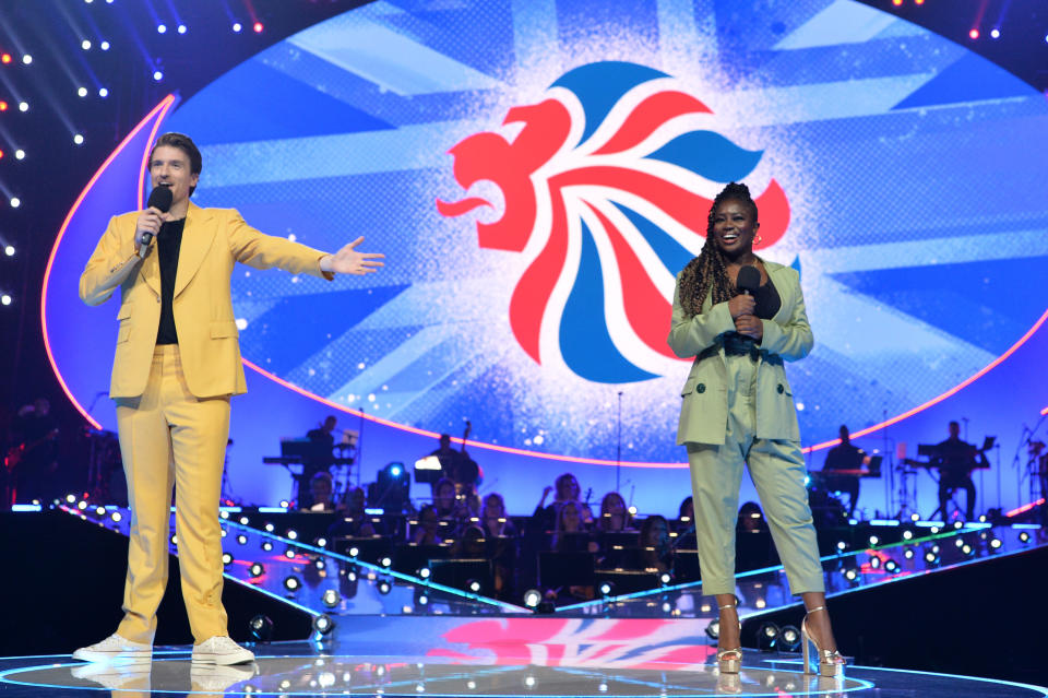 LONDON, ENGLAND - AUGUST 15: Greg James and Clara Amfo on stage during The National Lottery's Team GB homecoming event at the SSE Arena Wembley on August 15, 2021 in London, England. (Photo by Jeff Spicer/Getty Images for The National Lottery)