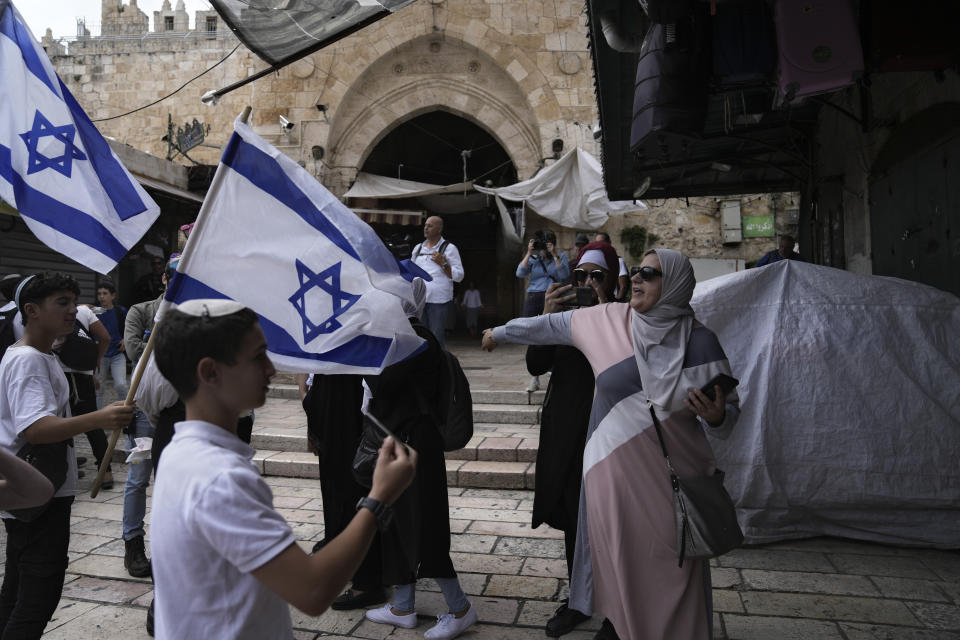 Israelis and Palestinians argue during a march marking Jerusalem Day, an Israeli holiday celebrating the capture of east Jerusalem in the 1967 Mideast war, in front of the Damascus Gate of Jerusalem's Old City, Thursday, May 18, 2023. Palestinians see the march as a provocation. (AP Photo/Mahmoud Illean)