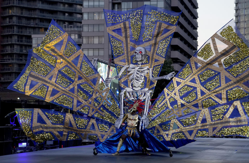 A Carnival masquerader performs during King and Queen Showcase at Lamport Stadium in Toronto, Canada, Thursday, July 28, 2022. The 55th annual parade returned to the streets after the COVID-19 pandemic cancelled it for two years in a row. (AP Photo/Kamran Jebreili)