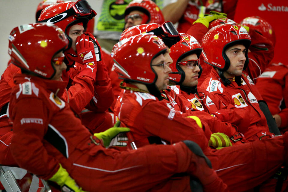 Members of the Scuderia Ferrari team watch the start of the Formula One Grand Prix at the Formula One Bahrain International Circuit in Sakhir, Bahrain, Sunday, April 6, 2014. (AP Photo/Patrick Baz, Pool)