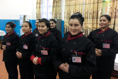 Residents stand in formation as reporters and officials arrive during a government organised visit to the Hotan county vocational educational training centre in Hotan county, Xinjiang Uighur Autonomous Region, China, January 5, 2019. REUTERS/Ben Blanchard