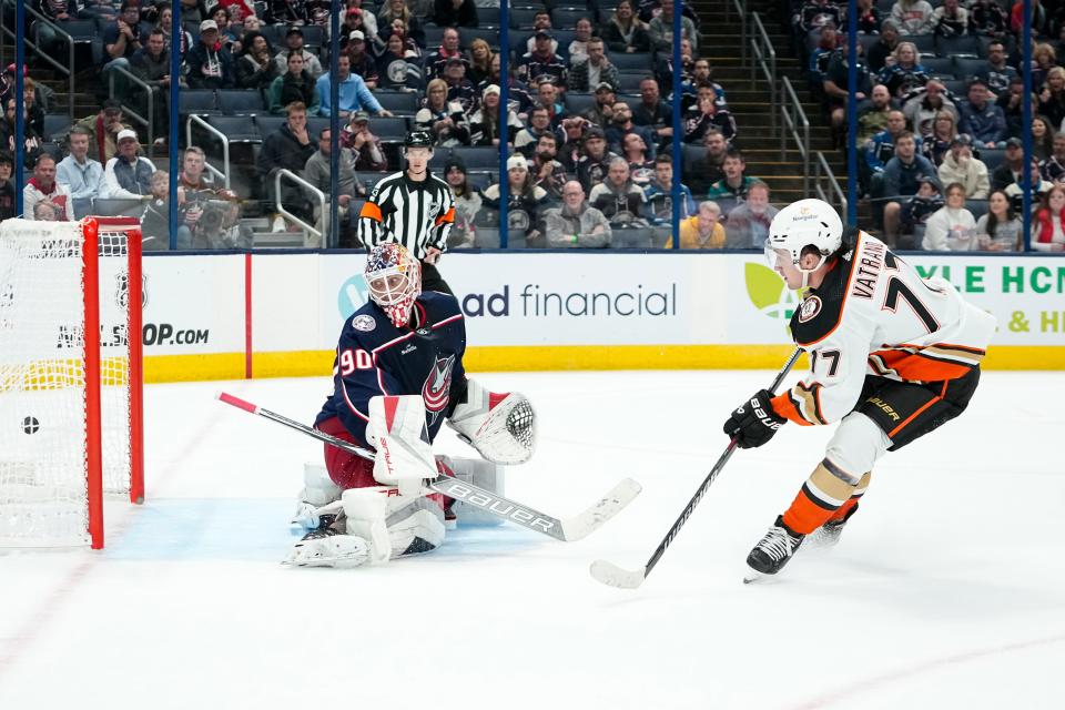 Oct 24, 2023; Columbus, Ohio, USA; Anaheim Ducks right wing Frank Vatrano (77) scores the game-winning goal past Columbus Blue Jackets goaltender Elvis Merzlikins (90) during overtime in the NHL game at Nationwide Arena. The Blue Jackets lost 3-2.