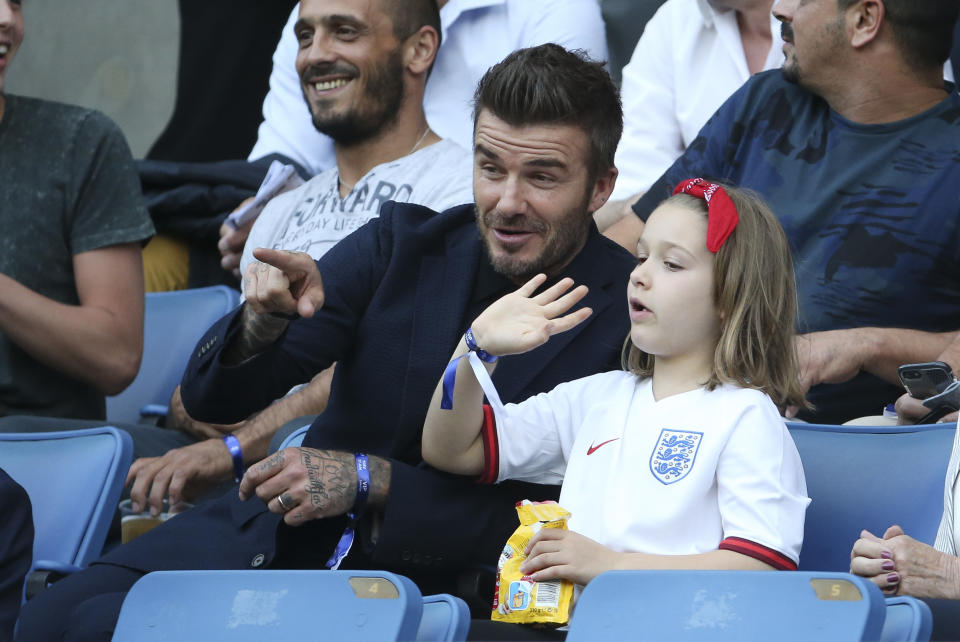 David Beckham watches on with his daughter Harper. (Credit: Getty Images)