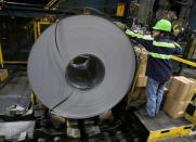 A finished steel coil is secured by a worker at the Novolipetsk Steel PAO steel mill in Farrell, Pennsylvania, U.S., March 9, 2018. REUTERS/Aaron Josefczyk