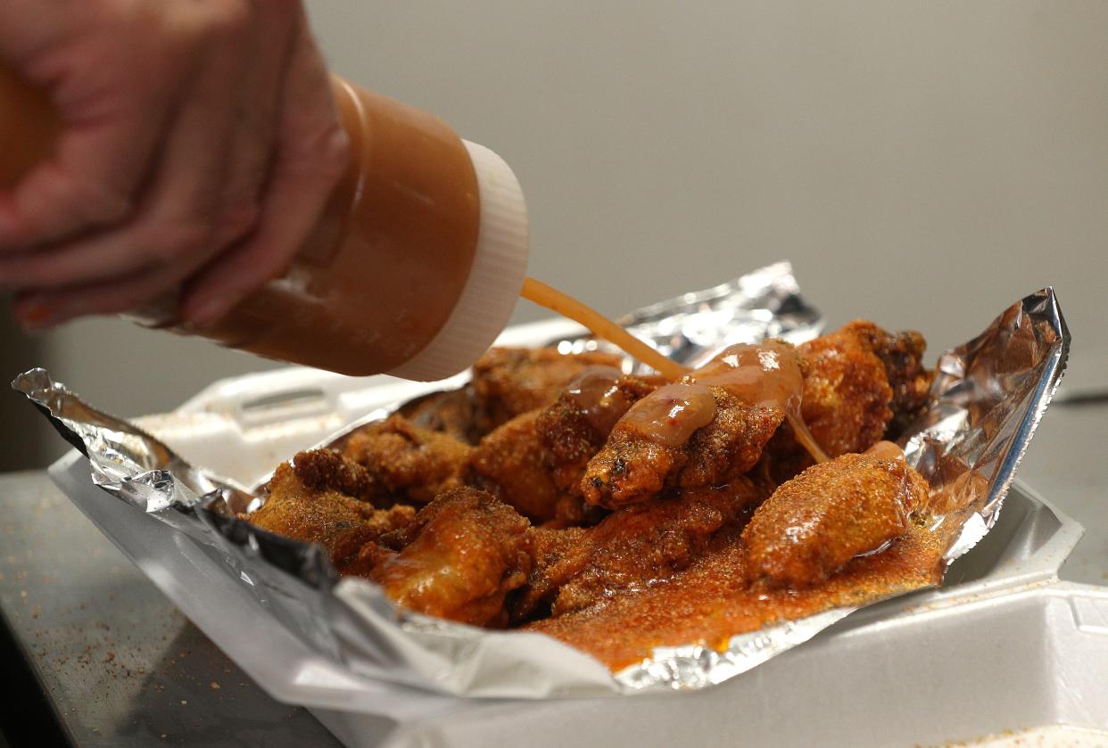 Windjammer's Lee Selover uses a layered approach to some of his wings flavors.  He tosses in a sauce then adds a dry rub seasoning and another sauce. 