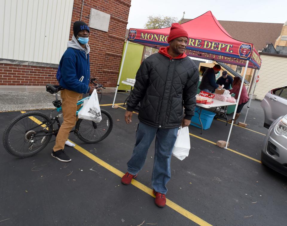 Alexis Braggs and Christopher Pippens of Monroe picked up three Thanksgiving dinners prepared by the City of Monroe firefighters and paramedics  Wednesday, November 24, 2021.