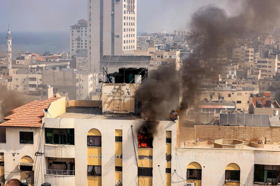 A fire rages on the top floor of a building hit by an Israeli airstrike on Wednesday in Gaza City (AFP via Getty Images)