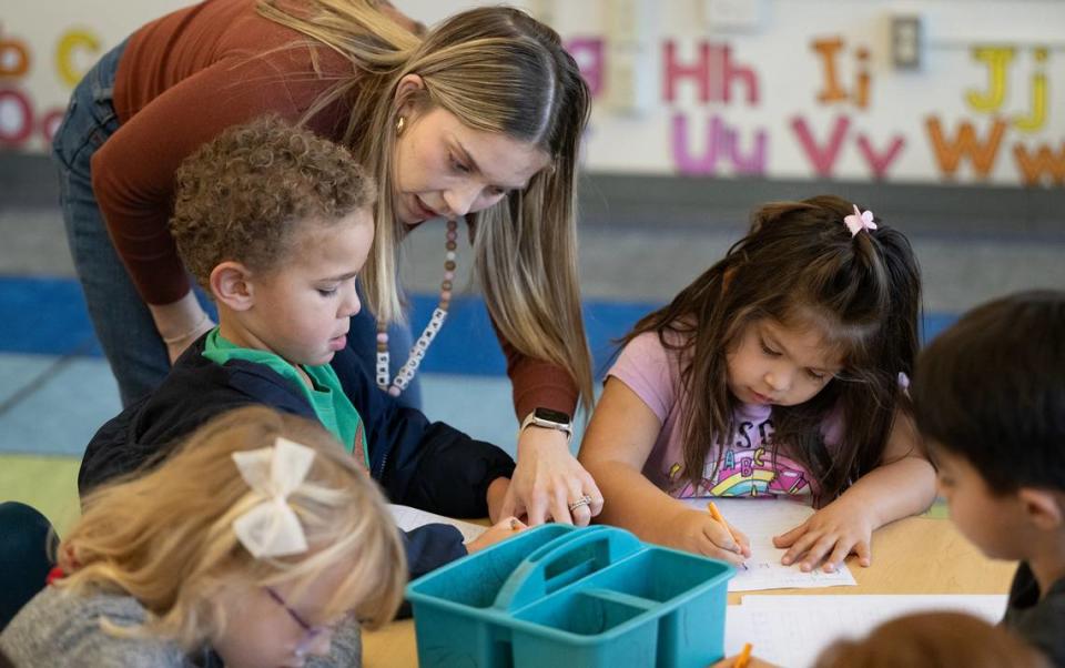 Transitional kindergarten teacher Morgan Stutsman helps student Leo Nelson, left, during a handwriting exercise at Fremont School in Modesto , Calif., Thursday, Dec. 7, 2023. The kindergarten students are working on motors skills and letter recognition to prepare them for cursive writing in later grades. In October, Gov. Gavin Newsom signed a law requiring cursive handwriting instruction mandatory in first through sixth grades effective Jan. 1. Andy Alfaro/aalfaro@modbee.com